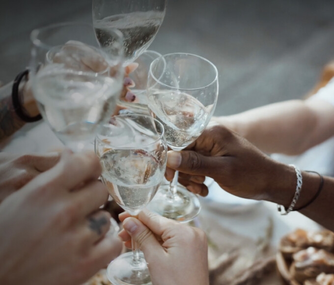 people cheering with toasts of wine