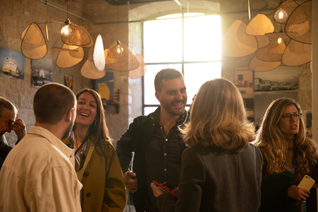 group of people conversing in rustic artistic building