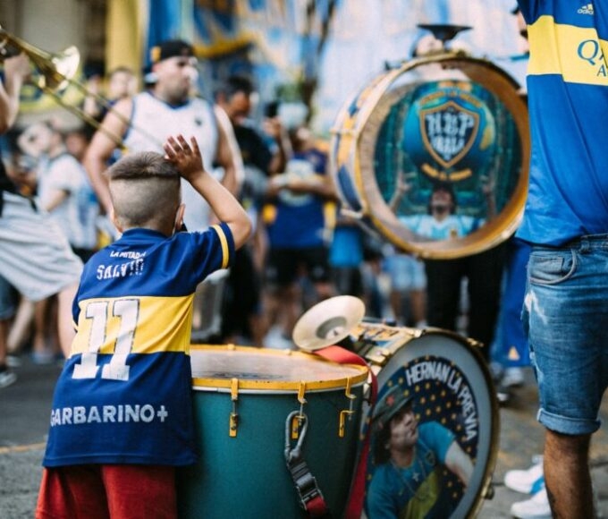 argentina child playing drum in town centre