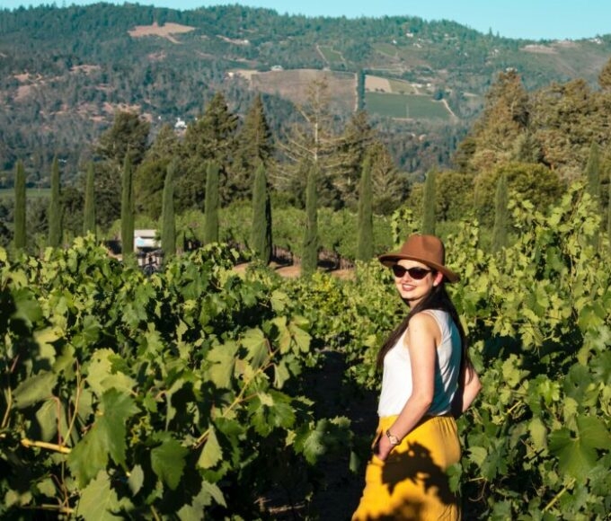 woman in california vineyard wearing hat