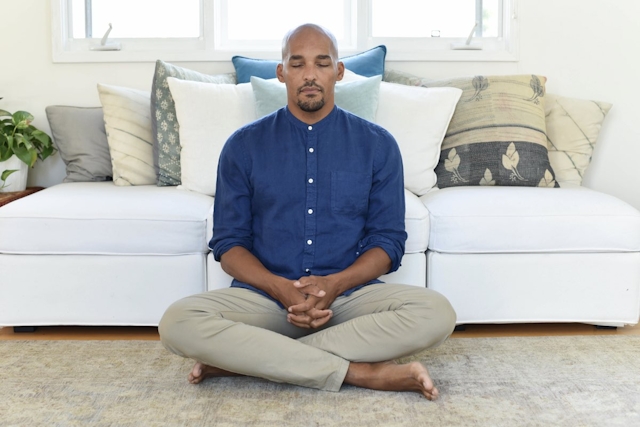 Man meditating in home