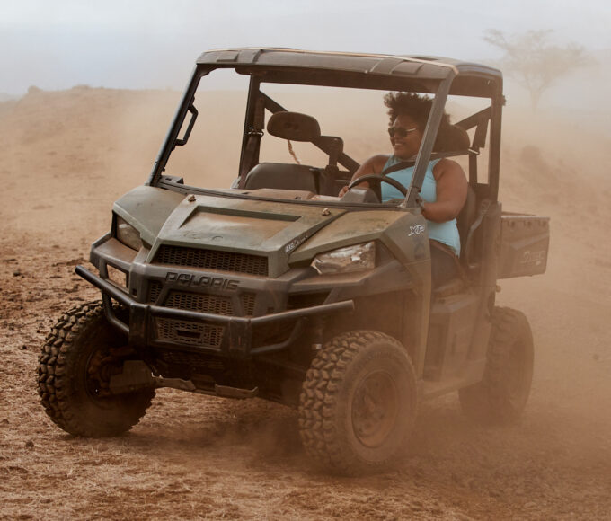 woman riding jeep in desert