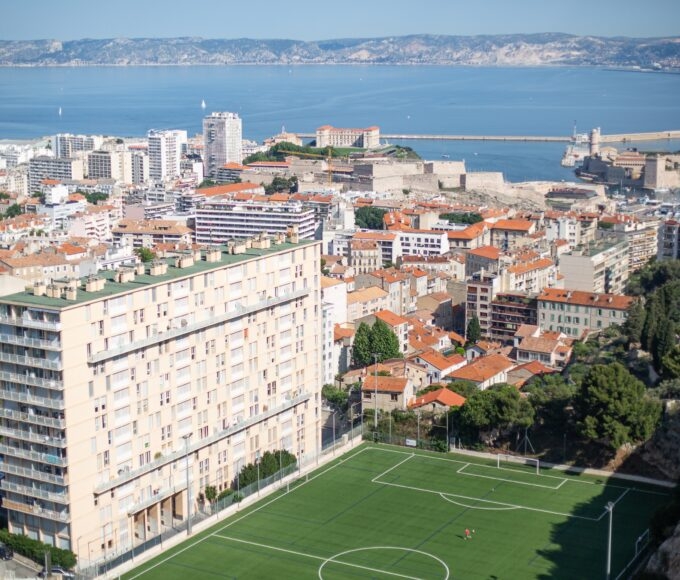 football stadium and large buildings overlooking sea