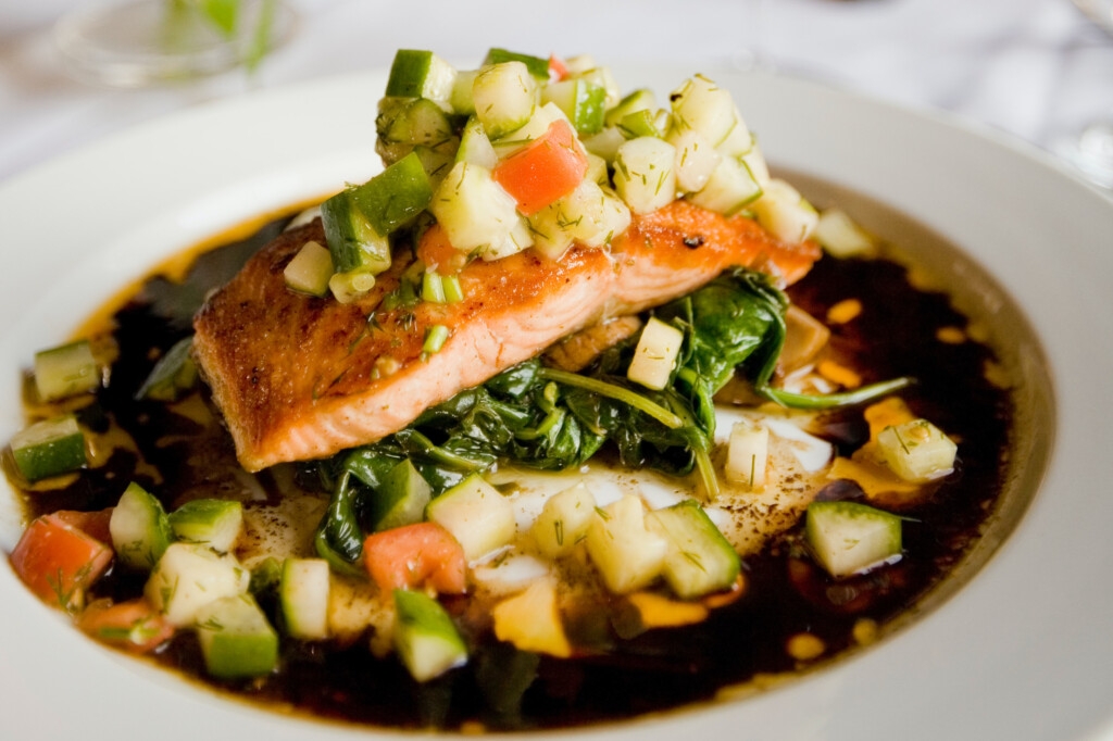 salmon with vegetables served in rich broth