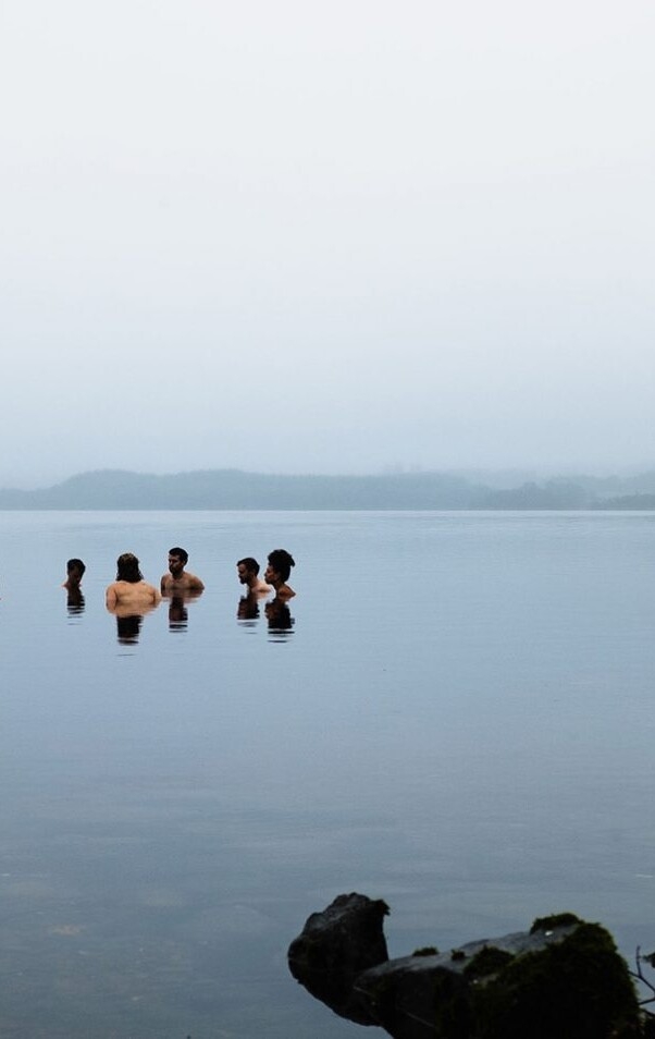People in a lake in a foggy morning