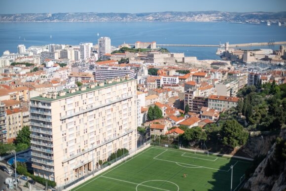 football stadium and large buildings overlooking sea
